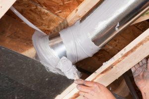 technician-applying-sealant-to-HVAC-ducts